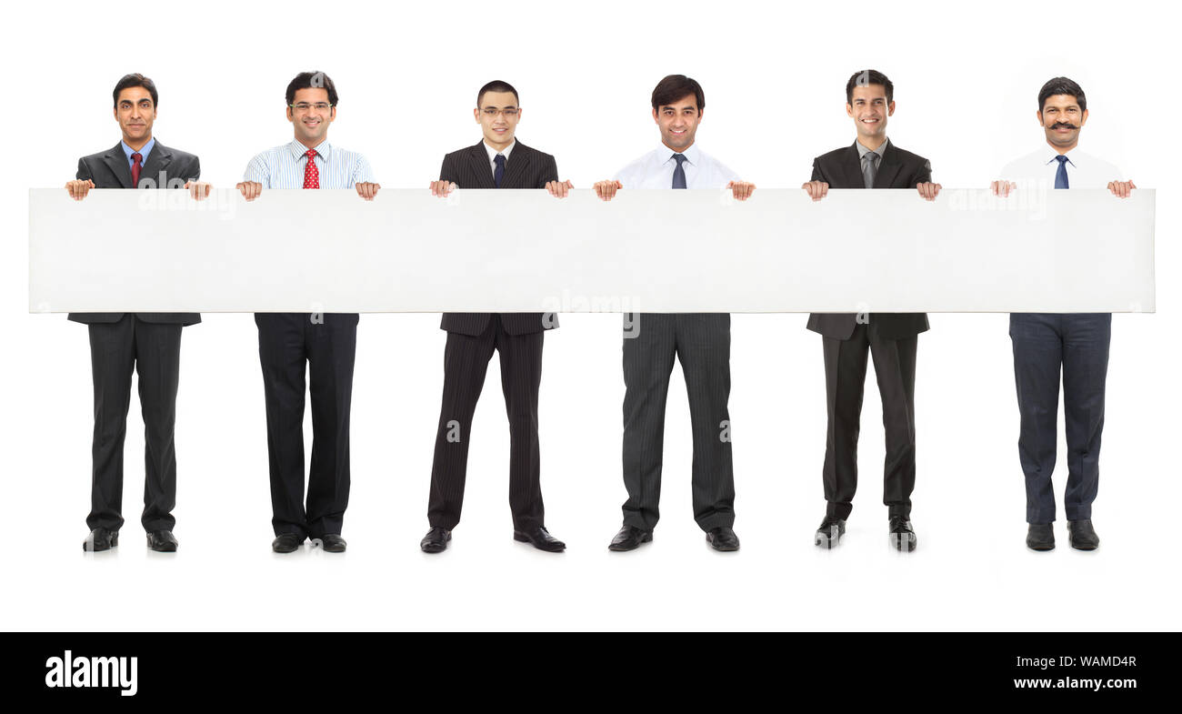 Business executives standing together and showing placard Stock Photo