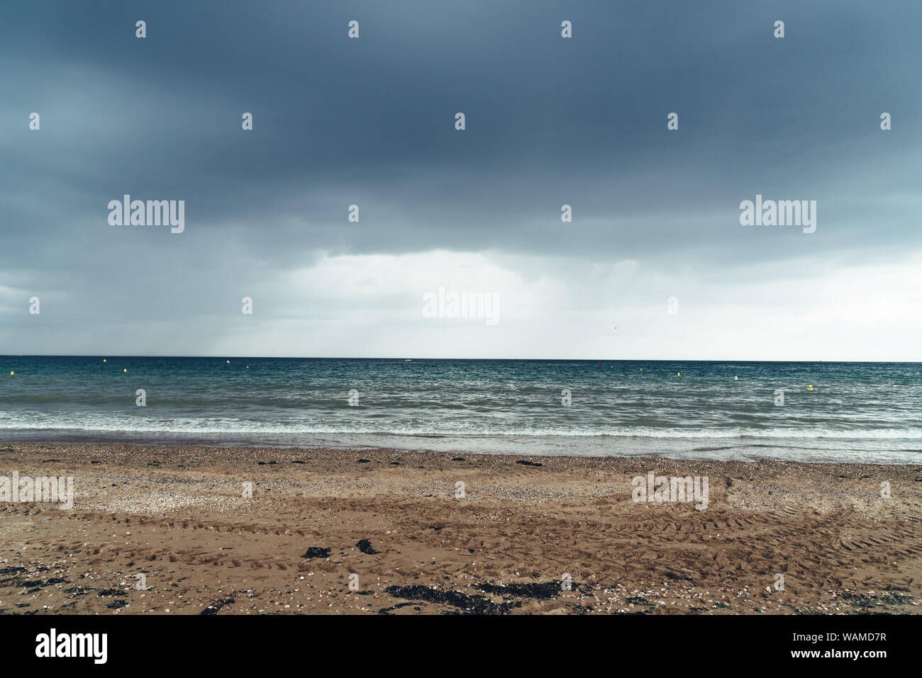 Beach with dark clouds and incoming rain storm. Vacation with bad ...