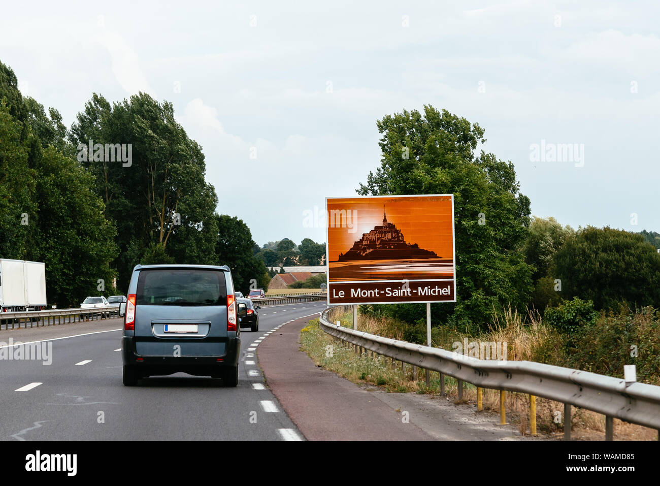 Road sign in highway announcing Mount Saint Michel. Stock Photo