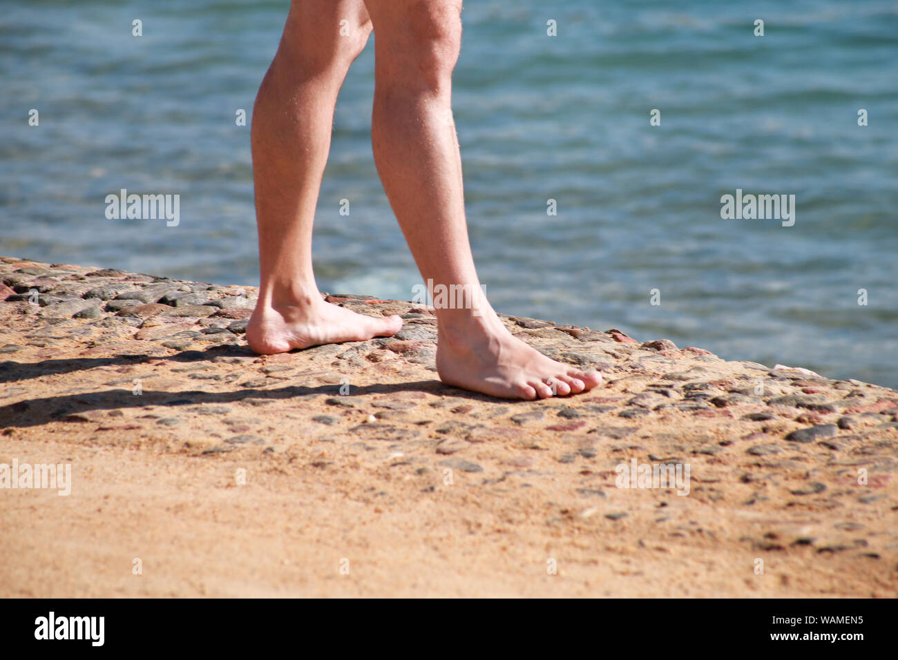 Man legs on sand. Male feet walking on beautiful sandy beach of hotel  resort on Red sea in Egypt, doing and leave behind footprints in sand Stock  Photo - Alamy