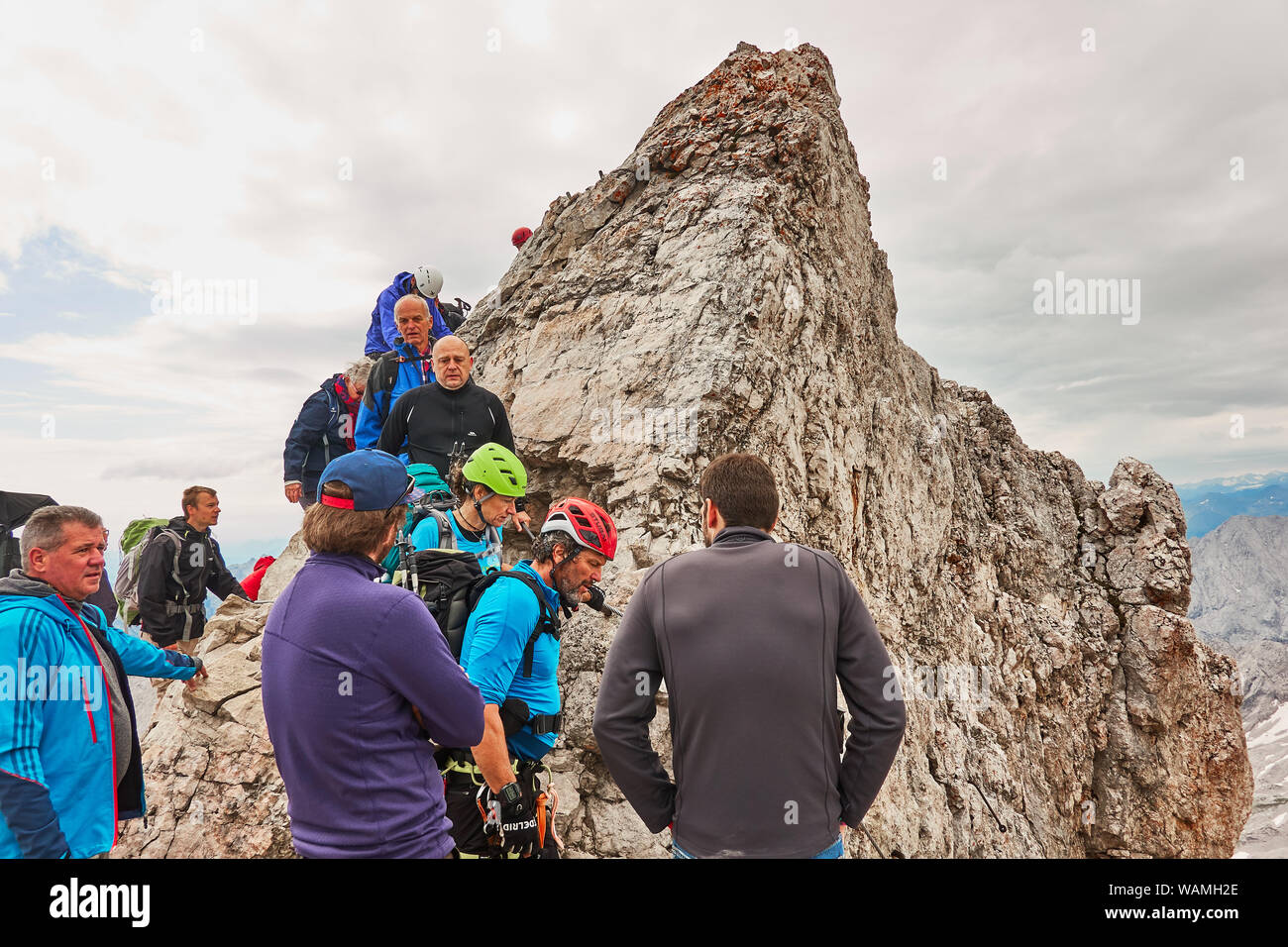 Garmisch-Partenkirchen, Germany, August 5., 2019: Exhausted mountaineers returning from the Zugspitze summit in Bavaria Stock Photo