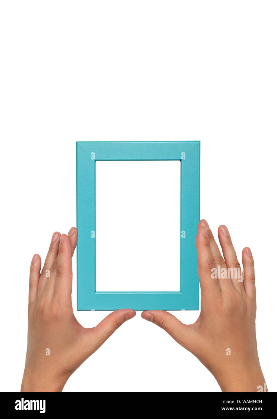 Blue photo frame in female hands. Empty blue frame template. Stock Photo