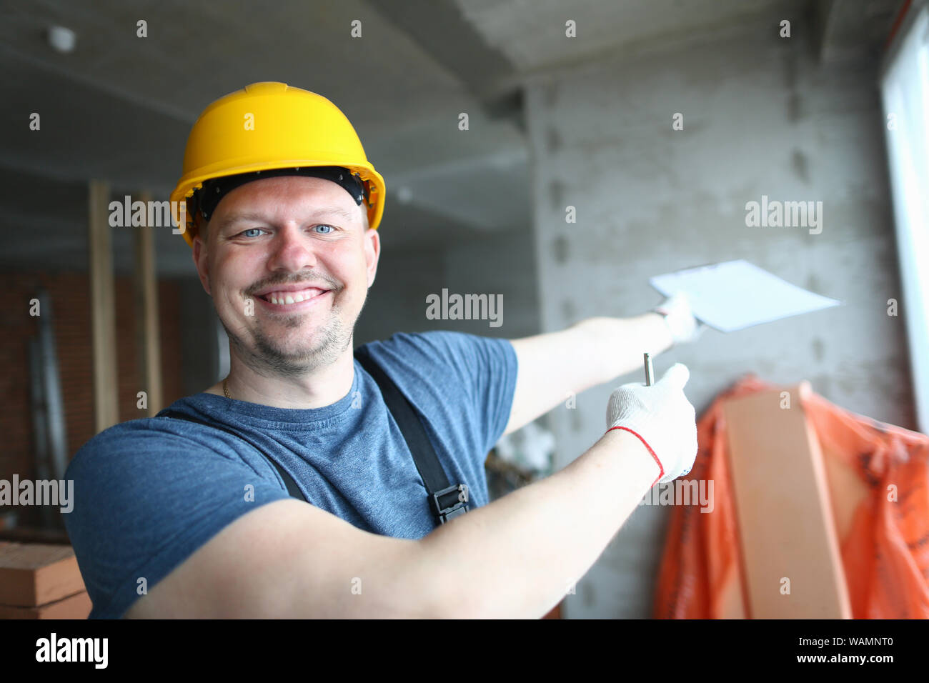 Cheerful builder looking at camera Stock Photo