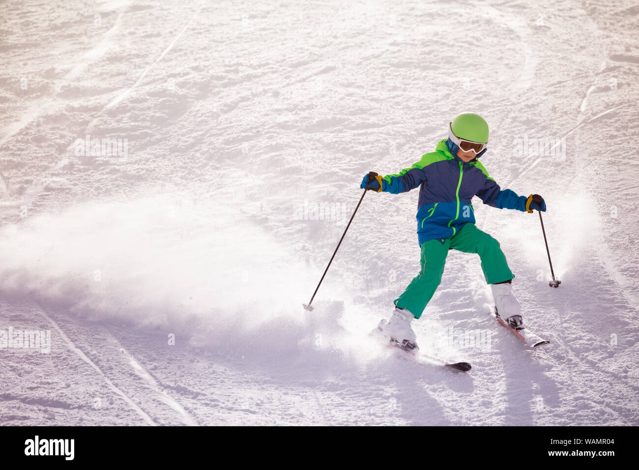 Little boy ski fast downhill on the mountain slope Stock Photo - Alamy