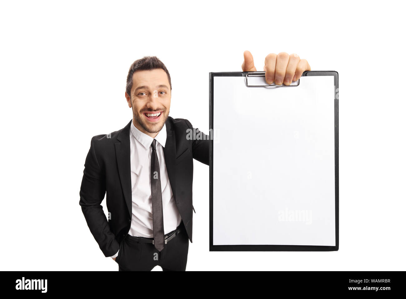 Young professional man in a suit smiling and holding a clipboard ...