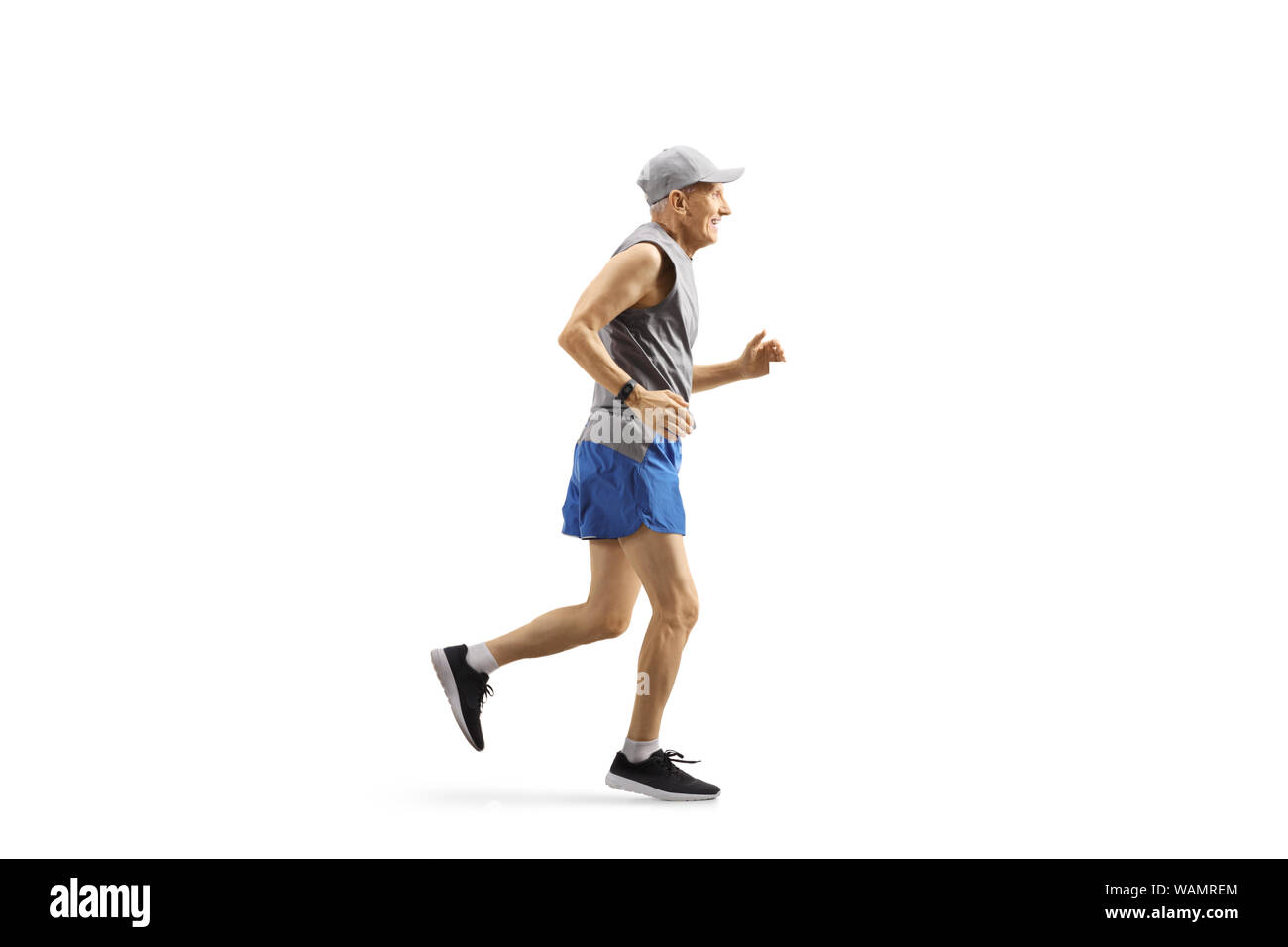 Full length profile shot of a senior man jogging isolated on white background Stock Photo