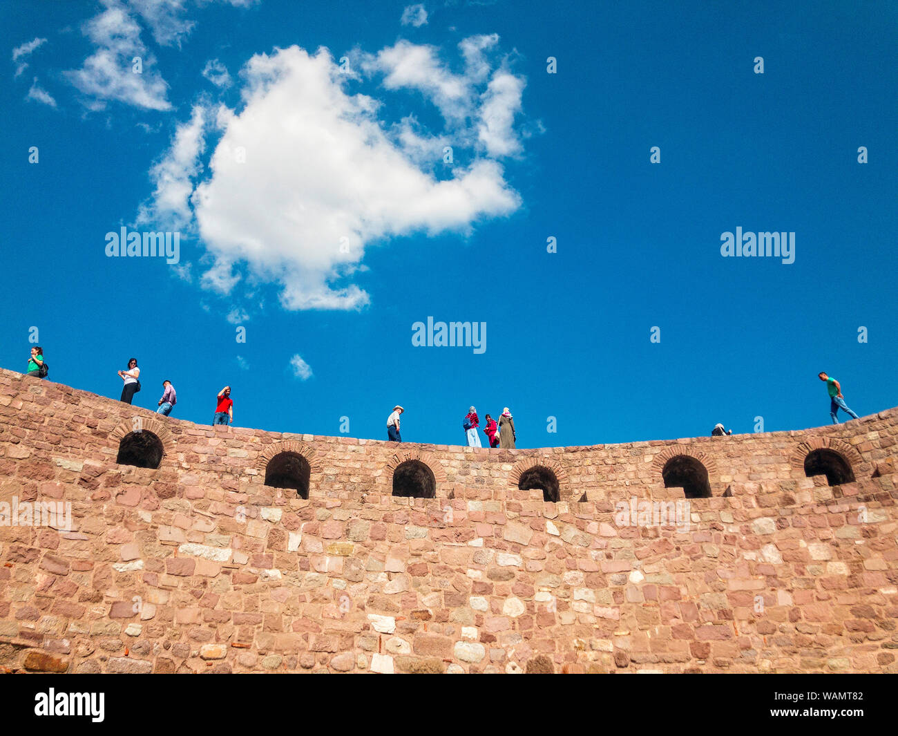 Panoramic view of the walls of Ankara Castle (Kalesi), people walking on the walls. Sunny day with clouds. Capital of Turkey. Historical monument Stock Photo