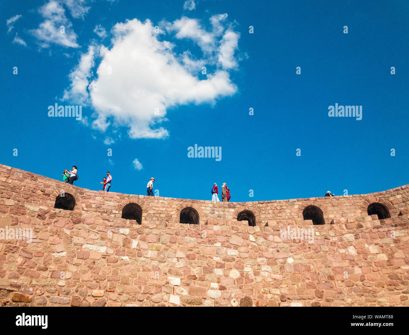 Panoramic view of the walls of Ankara Castle (Kalesi), people walking on the walls. Sunny day with clouds. Capital of Turkey. Historical monument Stock Photo