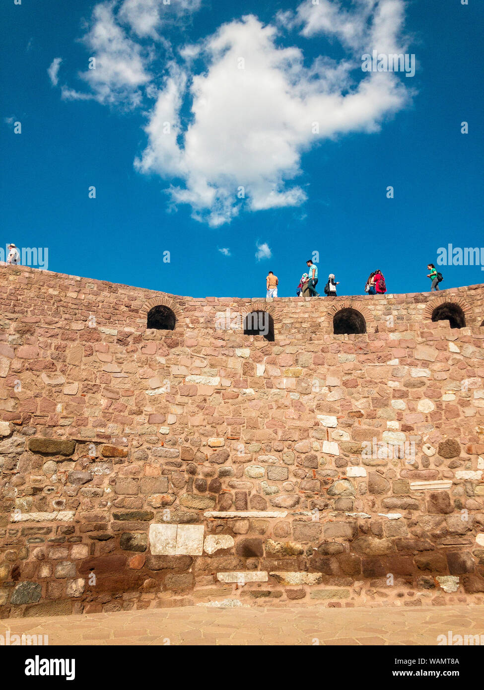 Panoramic view of the walls of Ankara Castle (Kalesi), people walking on the walls. Sunny day with clouds. Capital of Turkey. Historical monument Stock Photo