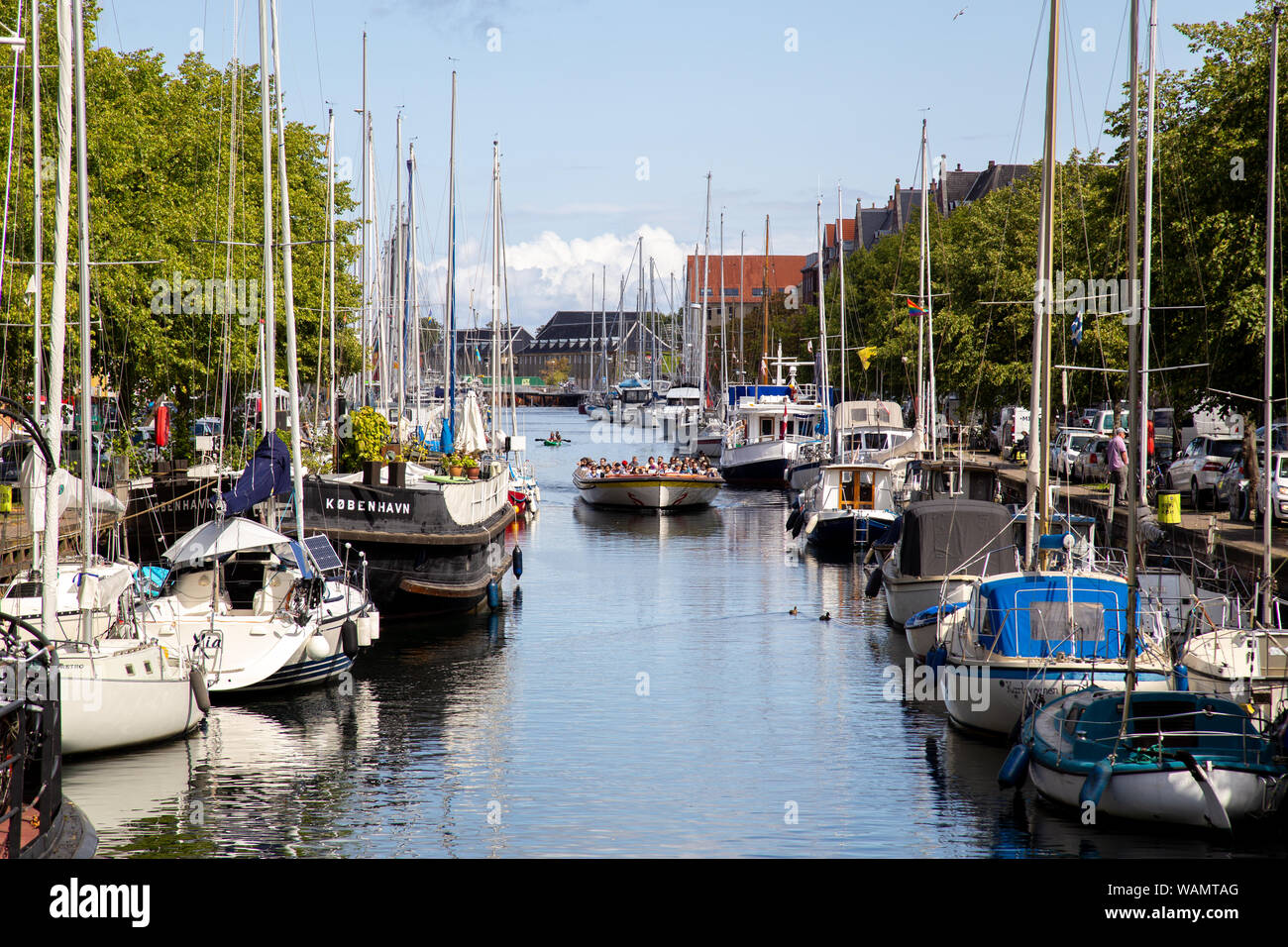 Tourist Boat in Christianshavn Canal in Copenhagen, Denmark Stock Photo