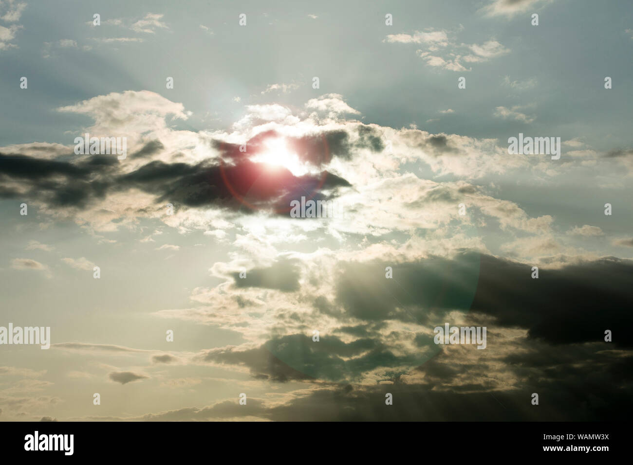 Sky with clouds lens flare dreamy sun lights fifty megapixels modern texture Stock Photo