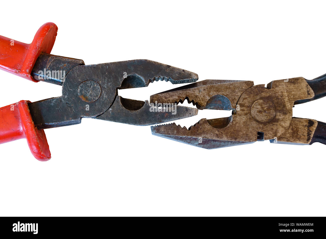 two used rusty worn pliers biting each other on a white background Stock Photo