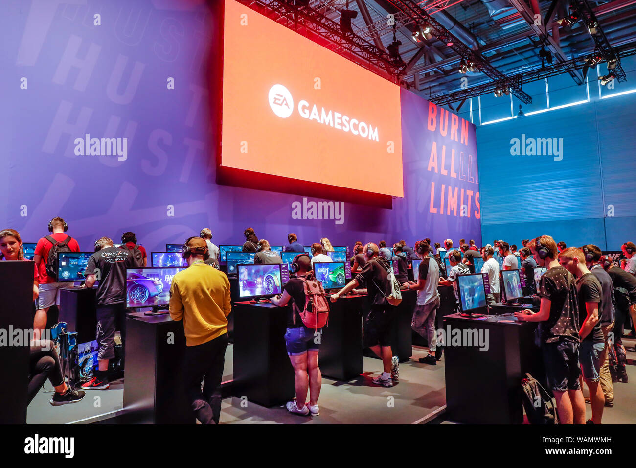 Cologne, North Rhine-Westphalia, Germany - Gamescom, trade fair visitors play the computer game NFS Heat, racing game Need for Speed Heat at Gamescom. Stock Photo