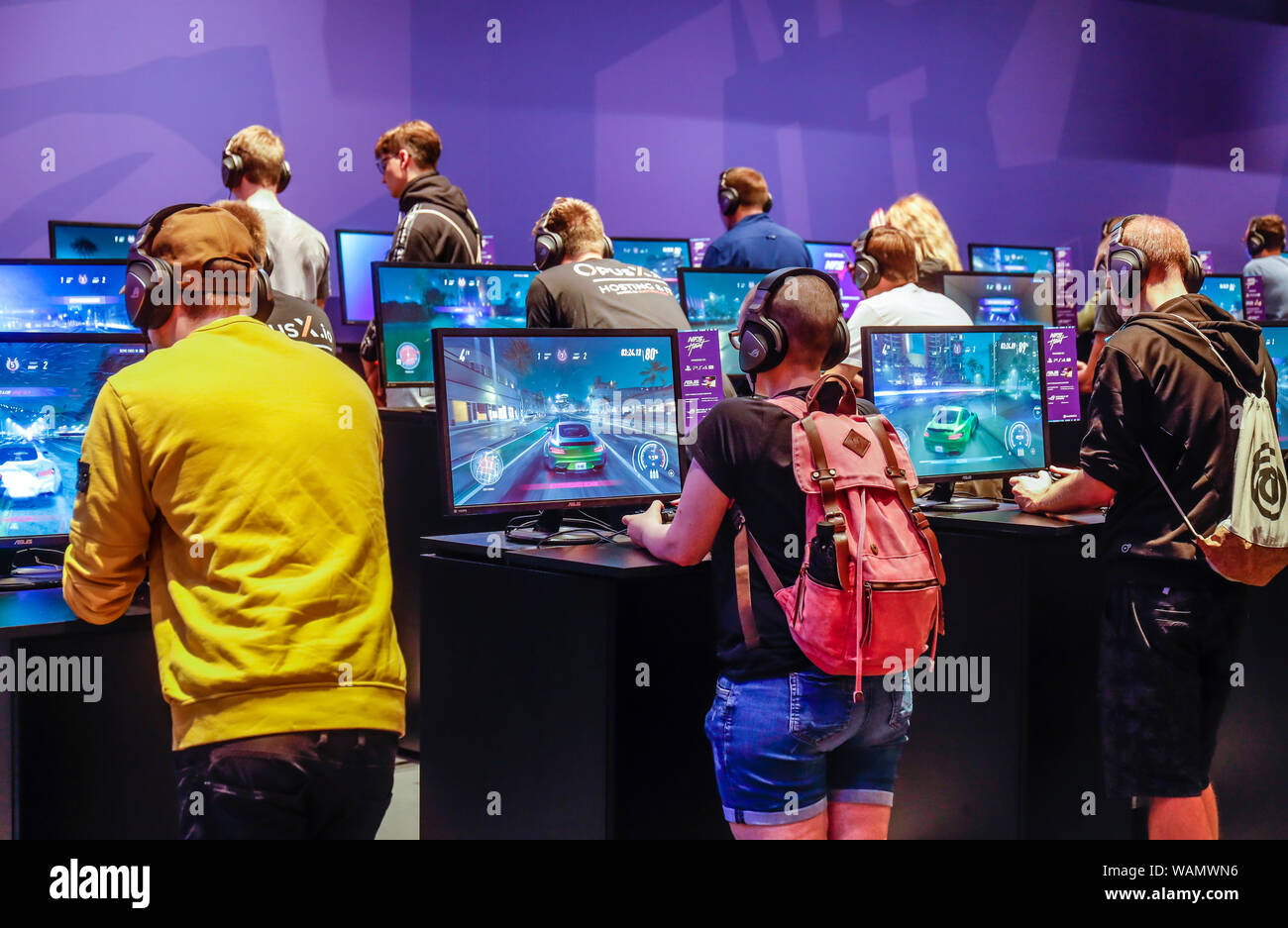 Cologne, North Rhine-Westphalia, Germany - Gamescom, trade fair visitors play the computer game NFS Heat, racing game Need for Speed Heat at Gamescom. Stock Photo