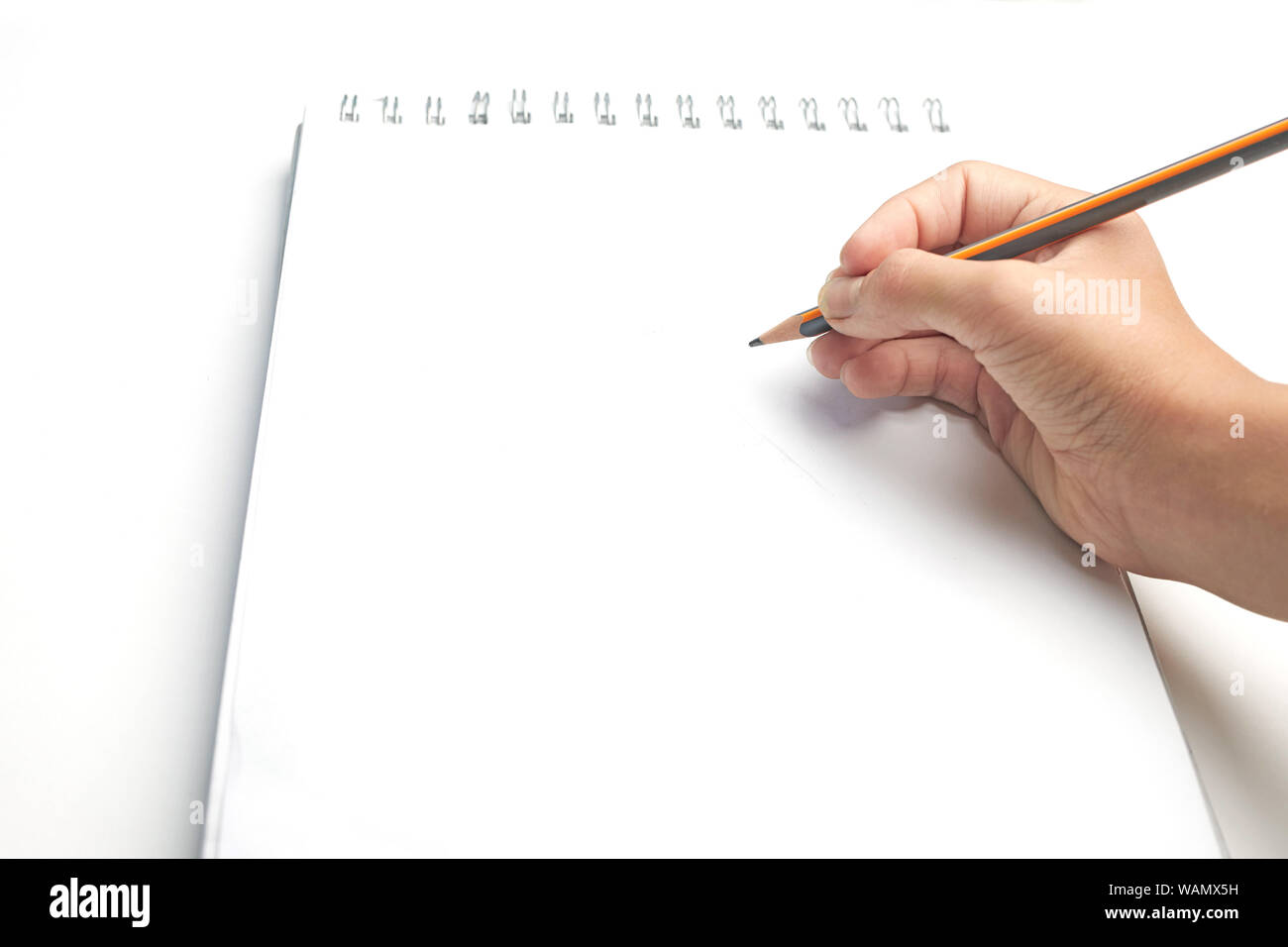 blank, template for drawing or sketching. Hand with pencil on a white album sheet ready to draw Stock Photo