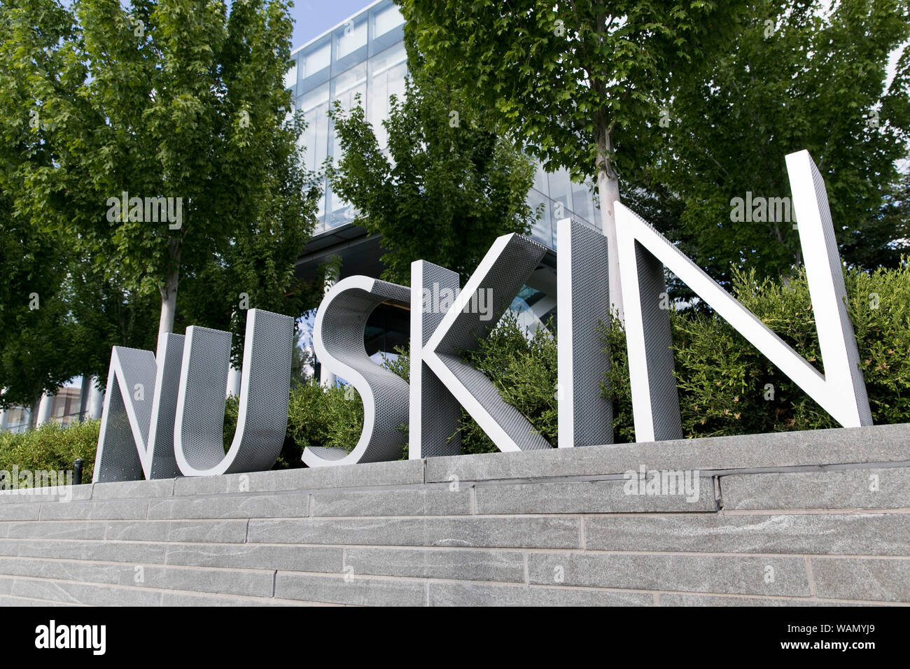 A logo sign outside of the headquarters of Nu Skin Enterprises in Provo, Utah on July 29, 2019. Stock Photo
