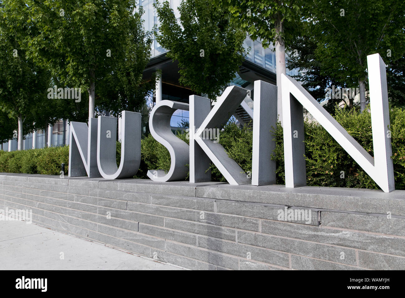 A logo sign outside of the headquarters of Nu Skin Enterprises in Provo, Utah on July 29, 2019. Stock Photo