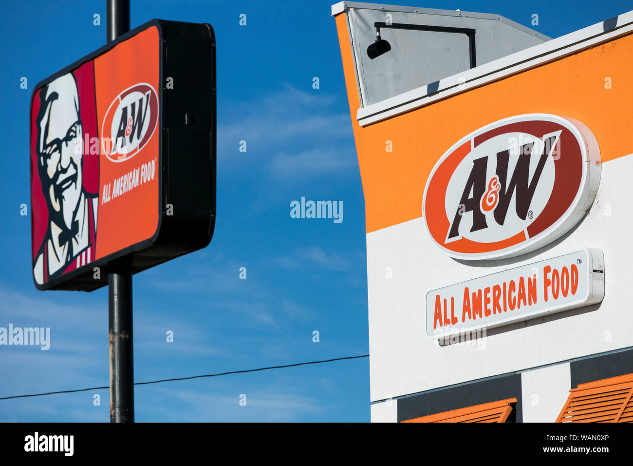 A logo sign outside of a A&W fast food restaurant location in American