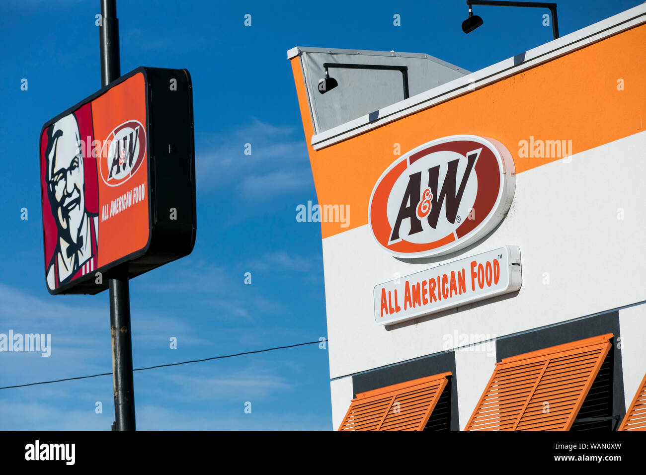 A logo sign outside of a A&W fast food restaurant location in American