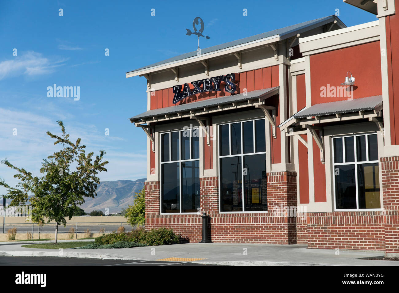A logo sign outside of a Zaxby's fast food restaurant location in