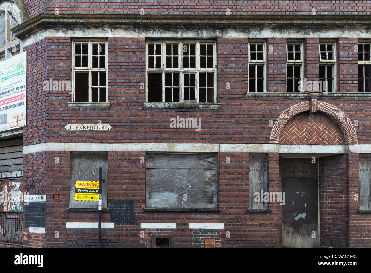 Old victorian factory building with boarded-up windows in Digbeth, Birmingham, UK Stock Photo