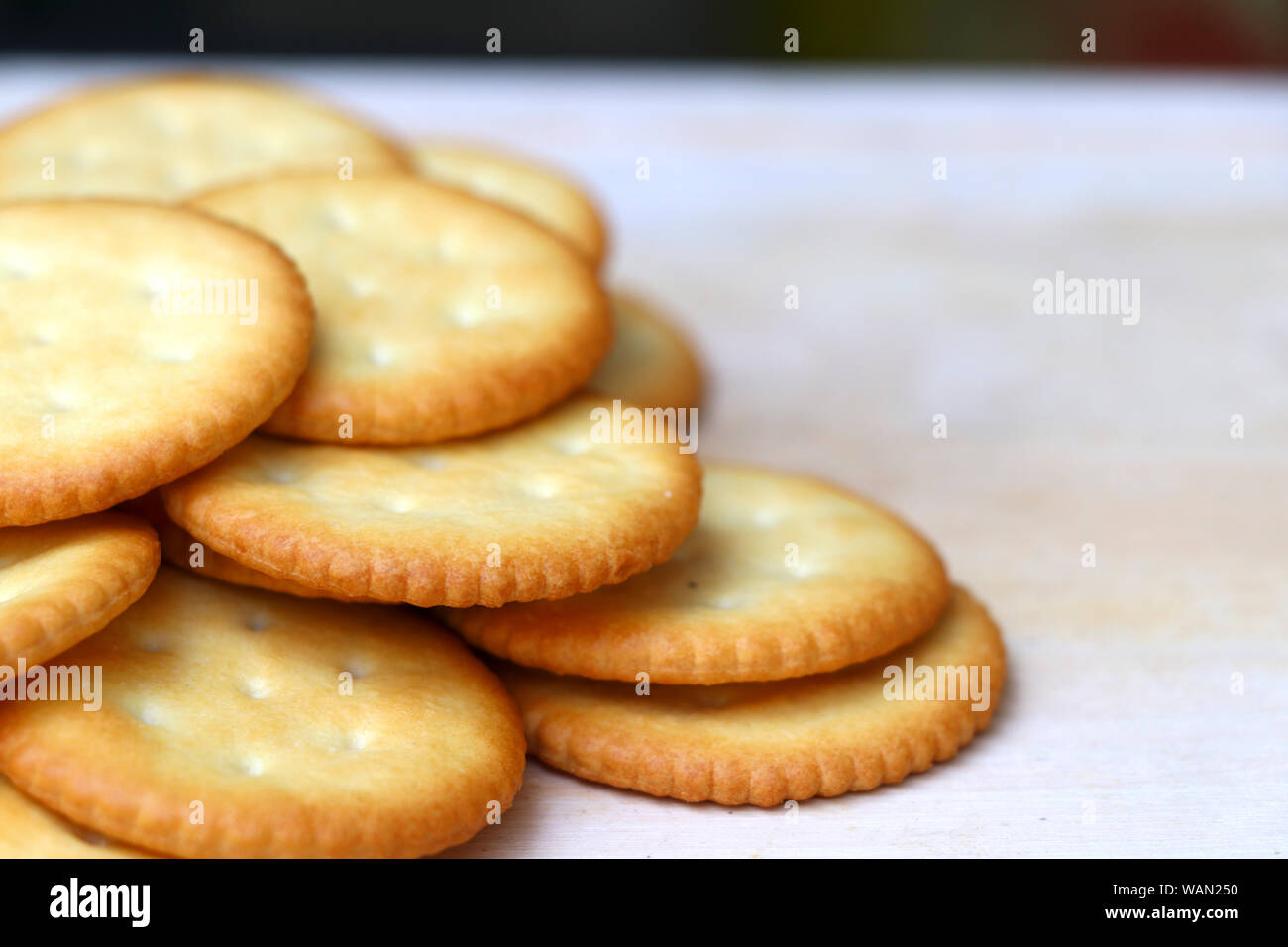 Biscuits are stacked on the wooden table with selective focus. Stock Photo