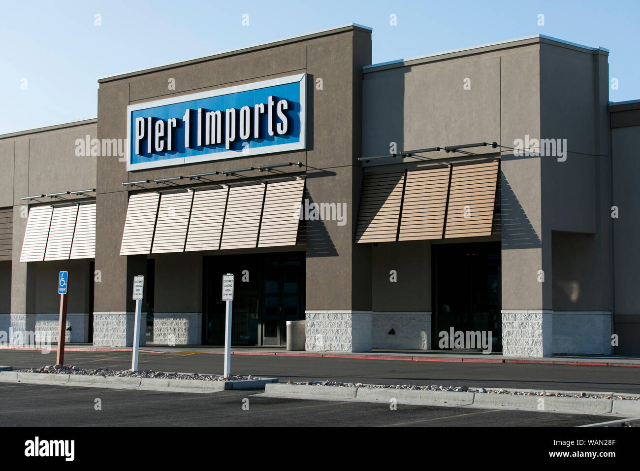 A logo sign outside of a Pier 1 Imports retail store location in Orem
