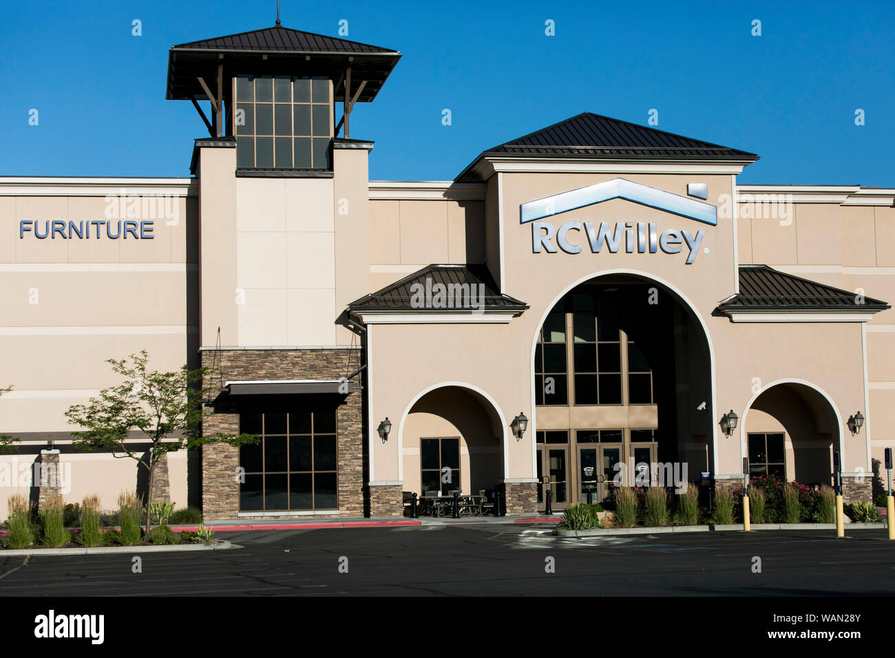 A logo sign outside of a RC Willey Home Furnishings retail store