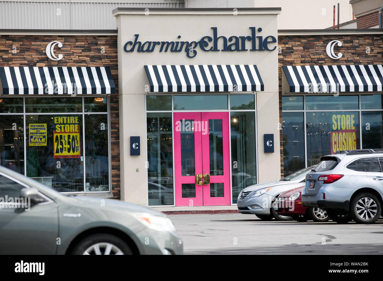 A logo and 'store closing' signs outside of a Charming Charlie retail store location in Orem, Utah on July 29, 2019. Stock Photo