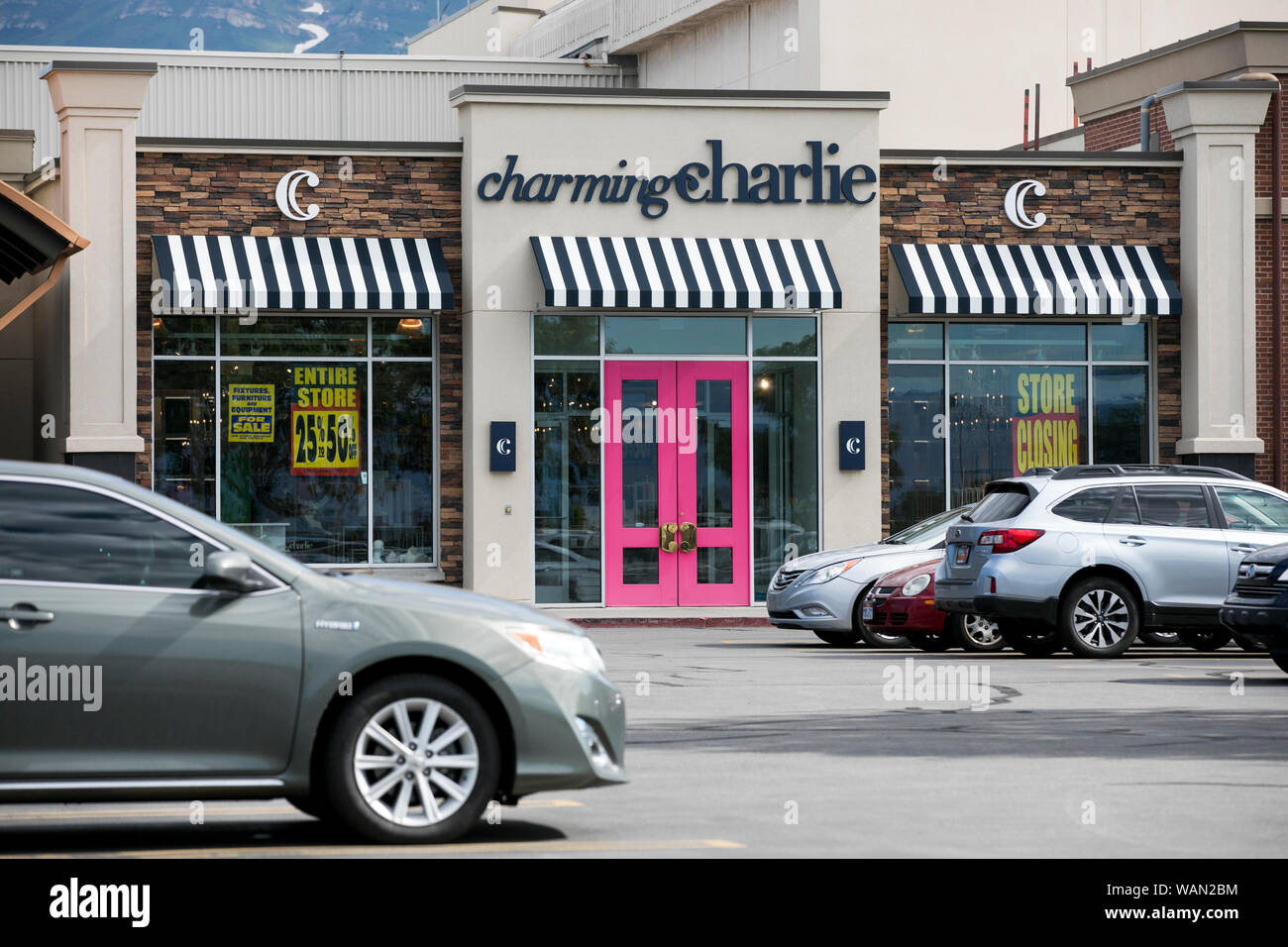 A logo and 'store closing' signs outside of a Charming Charlie retail store location in Orem, Utah on July 29, 2019. Stock Photo