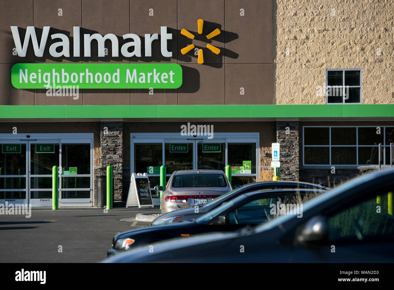 A logo sign outside of a Walmart Neighborhood Market retail store ...