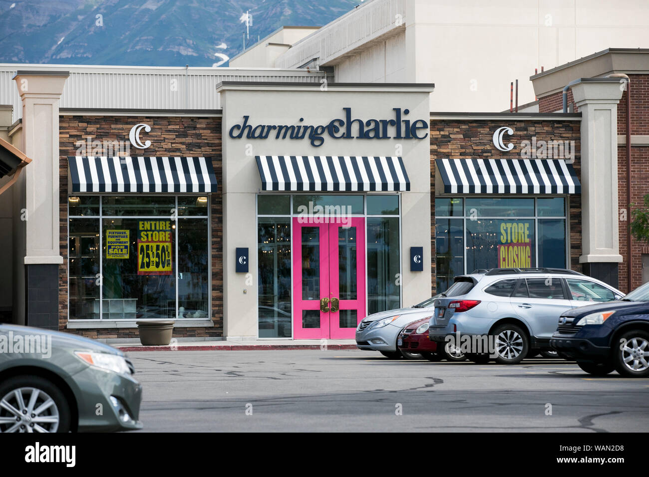 A logo and 'store closing' signs outside of a Charming Charlie retail store location in Orem, Utah on July 29, 2019. Stock Photo