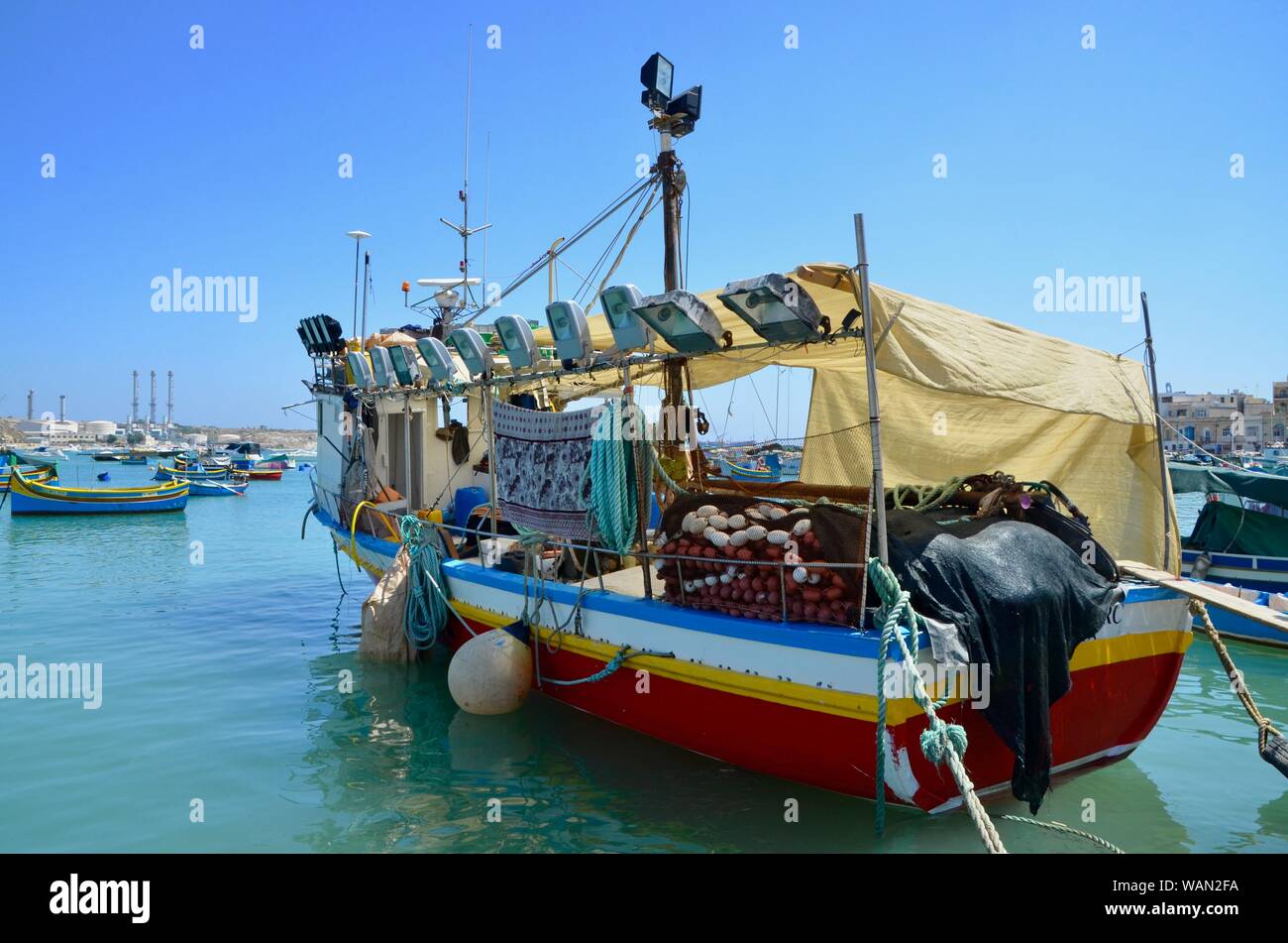 a fishing boat at  marsaxlokk malta sea front Stock Photo