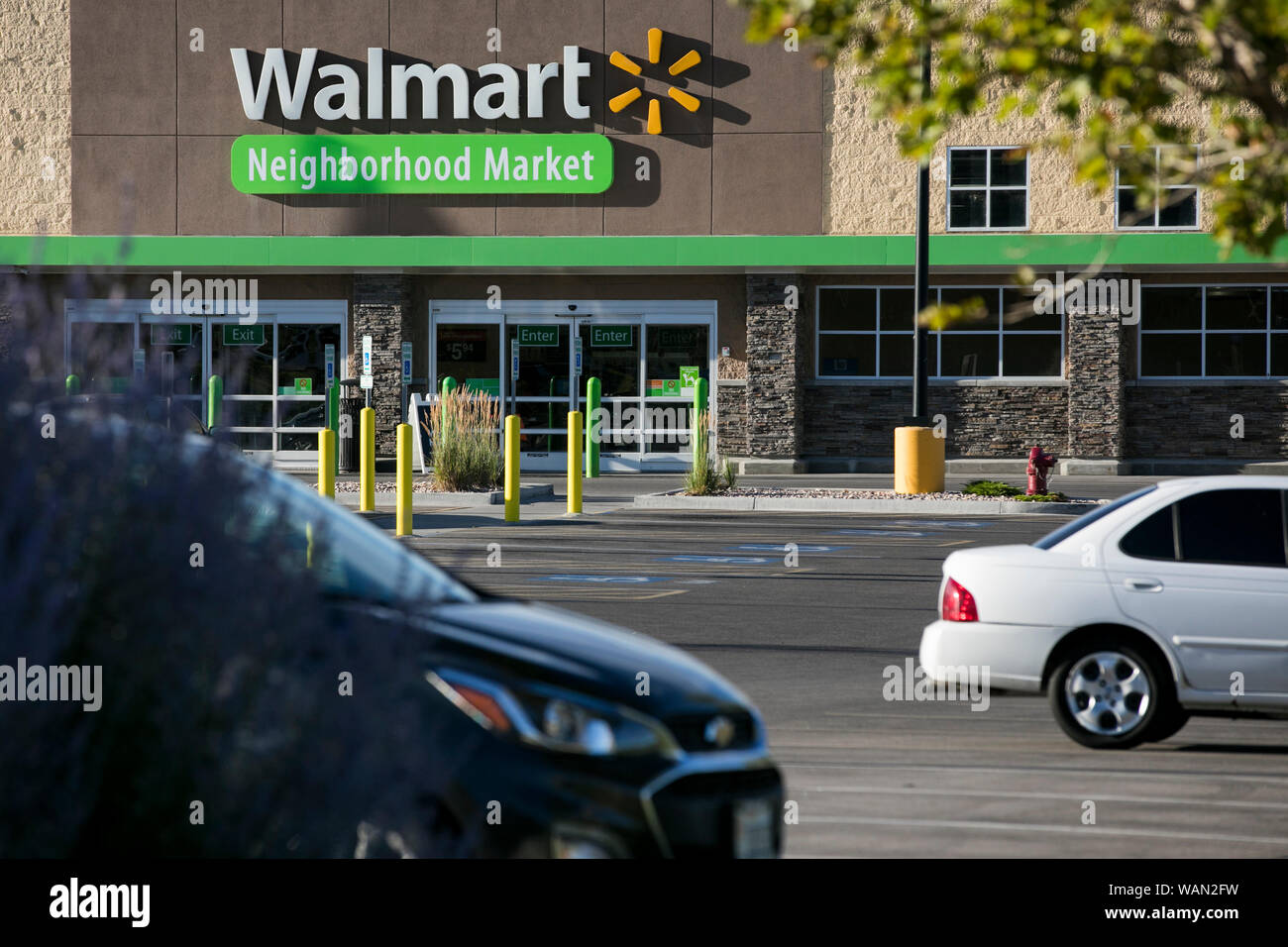 A logo sign outside of a Walmart Neighborhood Market retail store