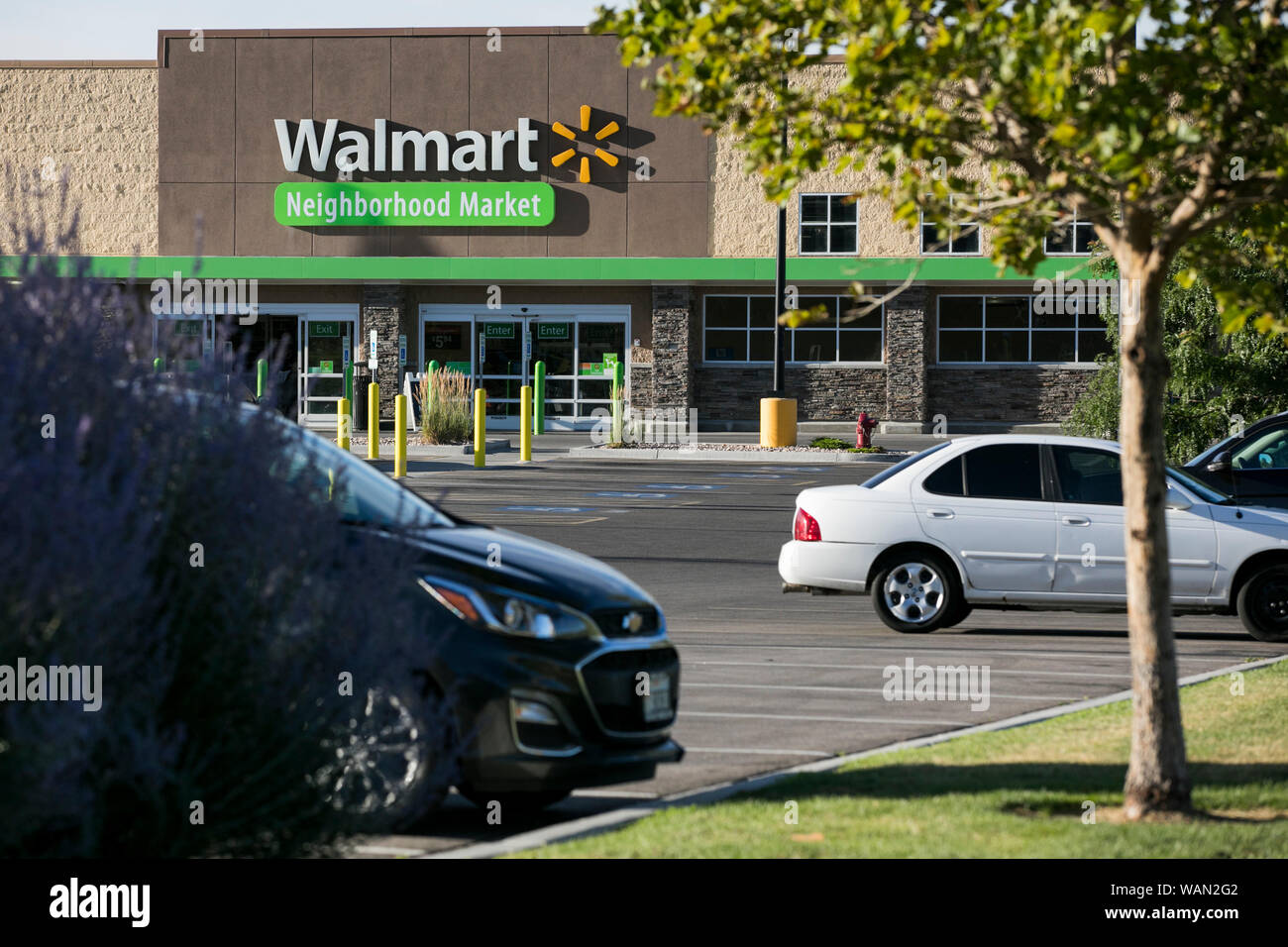 A logo sign outside of a Walmart Neighborhood Market retail store location in Pleasant Grove