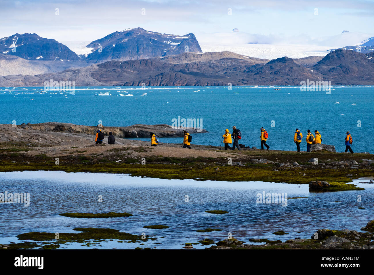 A group of travelers in the Arctic Spitzbergen landscape Stock Photo