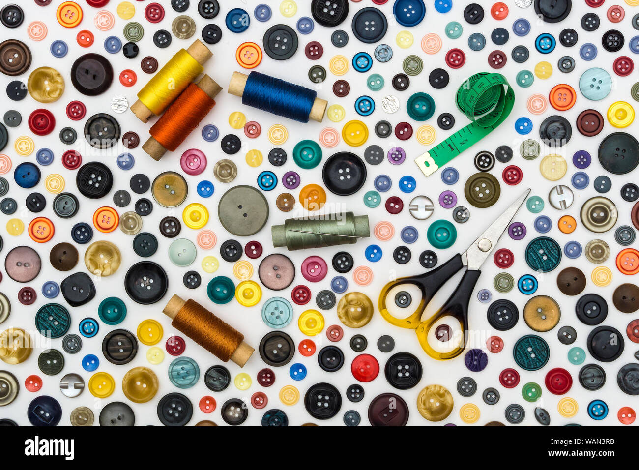 background - multicolored buttons and accessories for sewing on a white surface Stock Photo