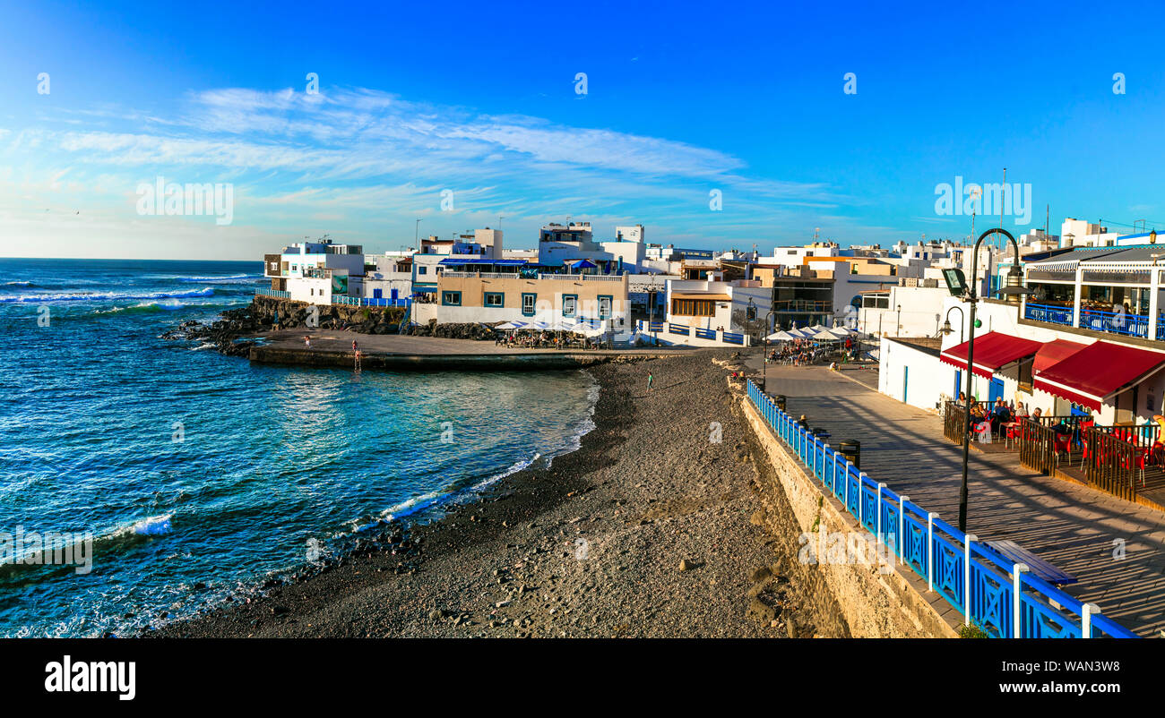 Traditional colorful houses,beach and sea in El Cotillo village,Fuerteventura island,Spain. Stock Photo