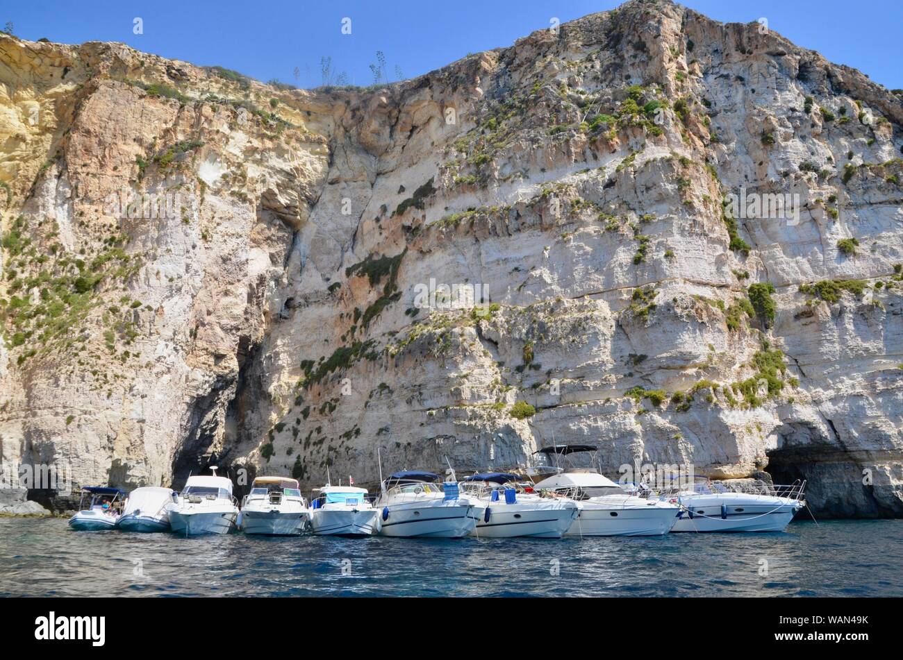 blue grotto malta tourist boats and yachts and queues Stock Photo