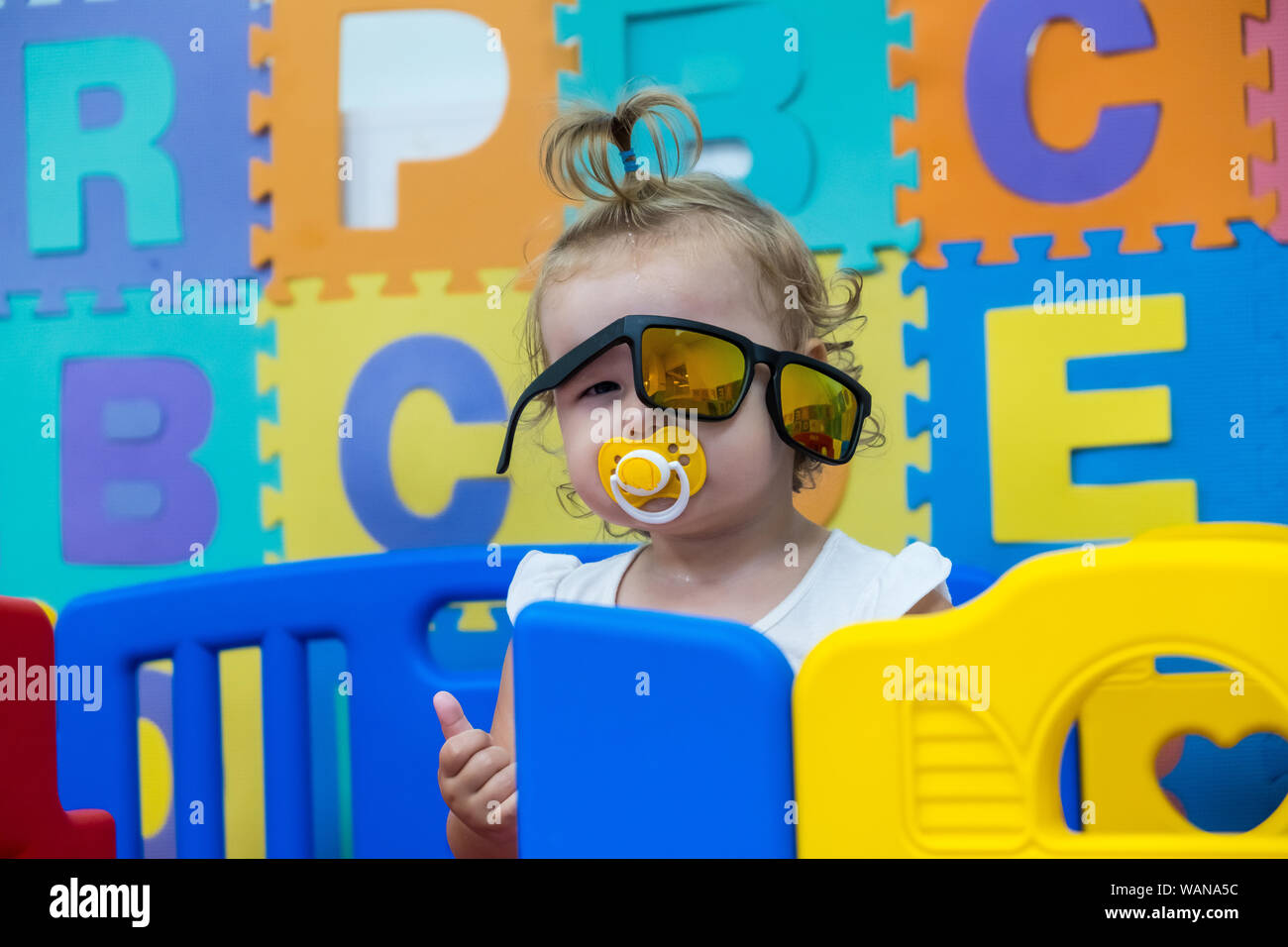 cute little girl plays with toys in the playroom, kindergarten Stock ...