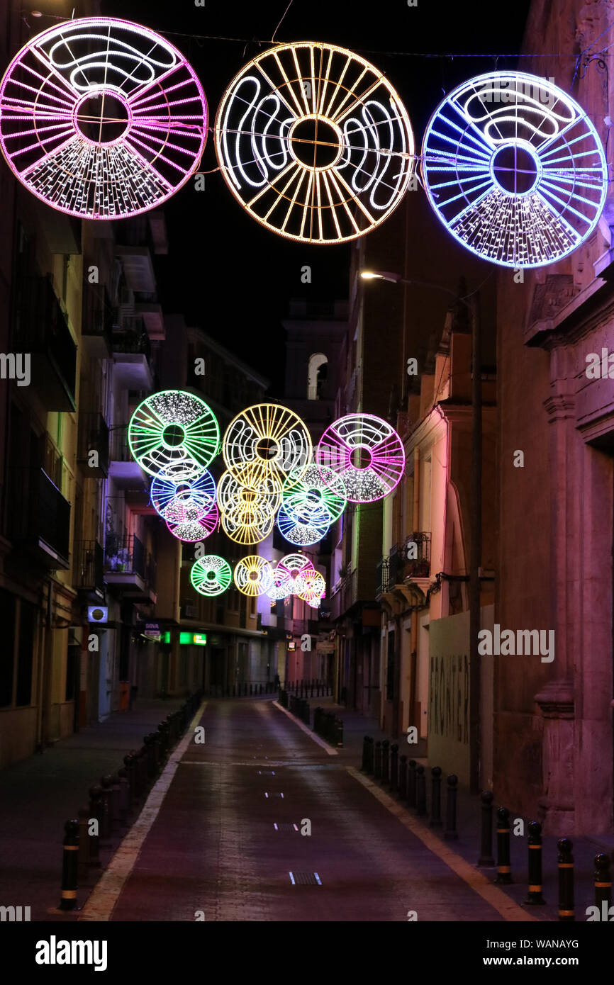 This is a view of a street in Almansa, Spain at night decorated with lights. Stock Photo