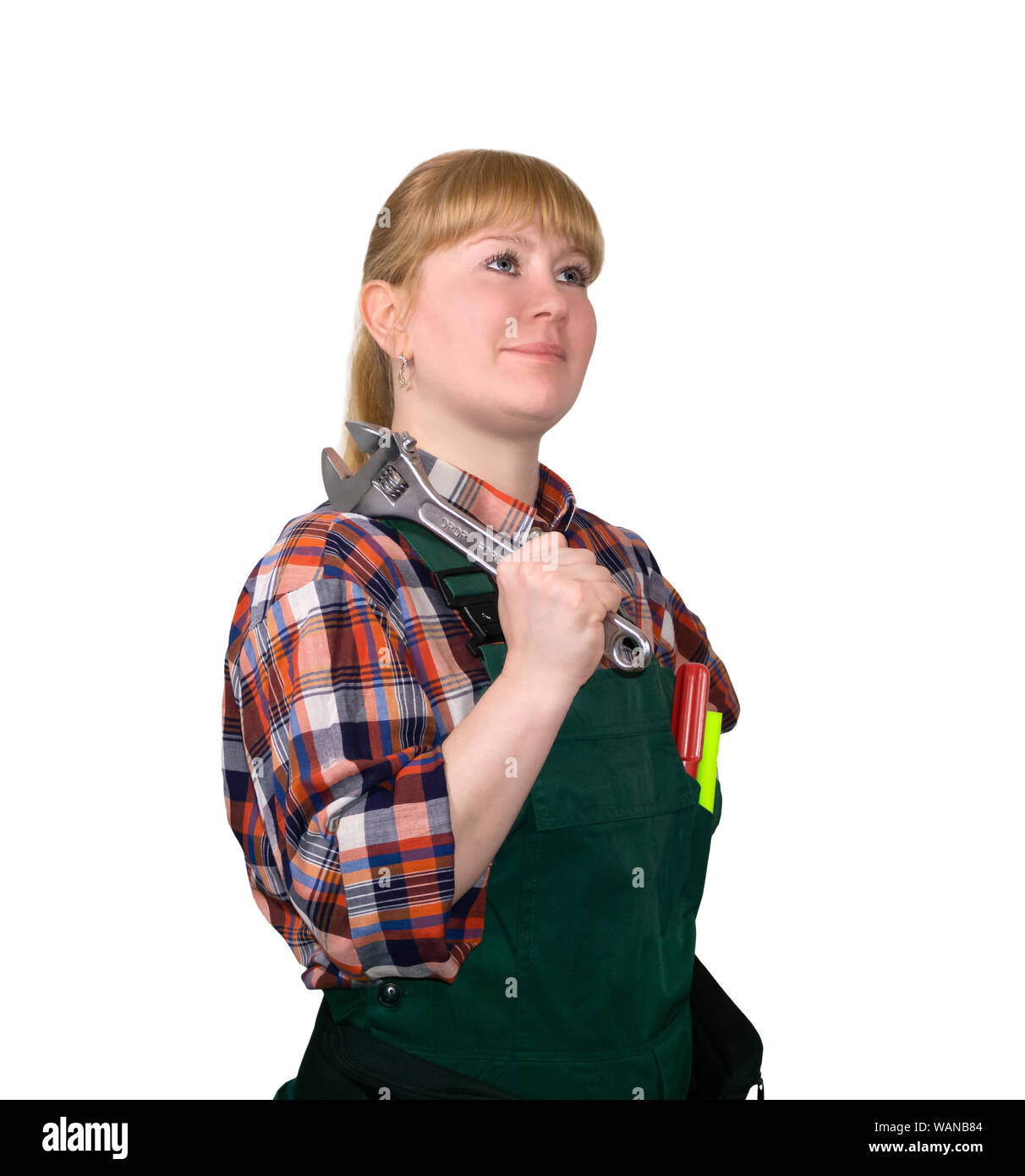 female auto mechanic in bib overalls with adjustable spanner, isolated