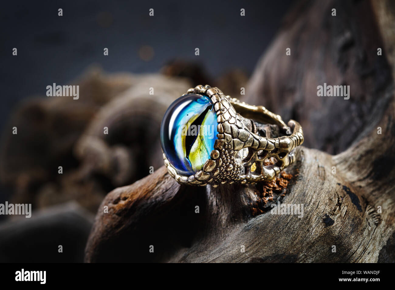 Creative ring with dragon eye on nature background, lampwork jewelry, close-up view Stock Photo