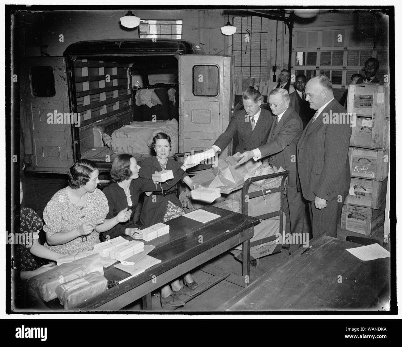 Counting of returns from unemployment questionnaire gets under way. Washington, D.C., Nov. 24. Tabulation of the returns from the millions of unemployment questionnaires mailed out last week was started today when final instructions were issued by John D. Biggers, Unemployment Census Director, to the hundreds of clerks employed to accomplish the huge task. Left to right: Director John D. Biggers; William L. Austin, Director of the Census; and Frederick A. Gosnell, representing the Lost Census Bureau at the Unemployment Census Tabulating, 11/24/37 Stock Photo