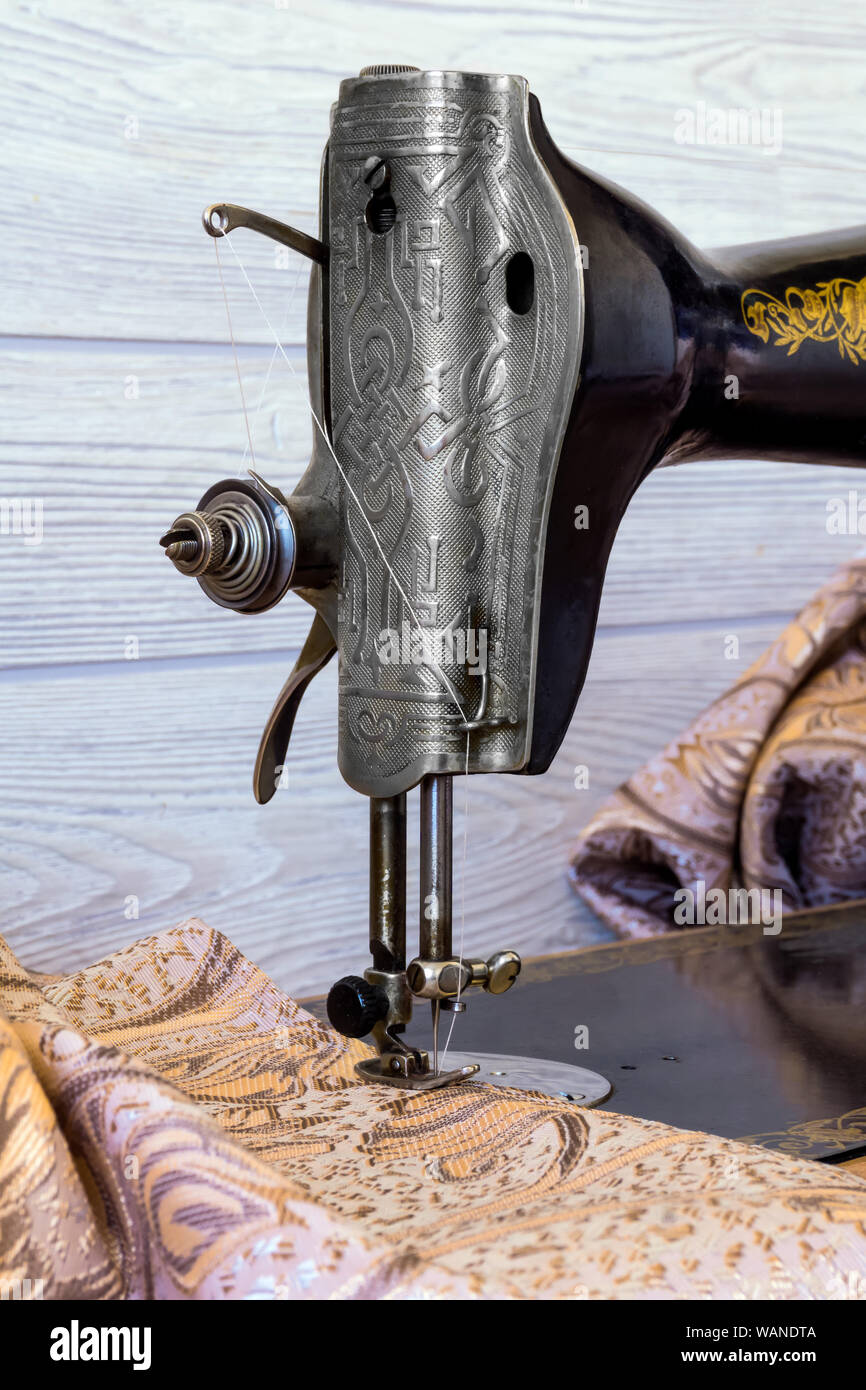 sewing head of antique sewing machine with presser foot during hemming