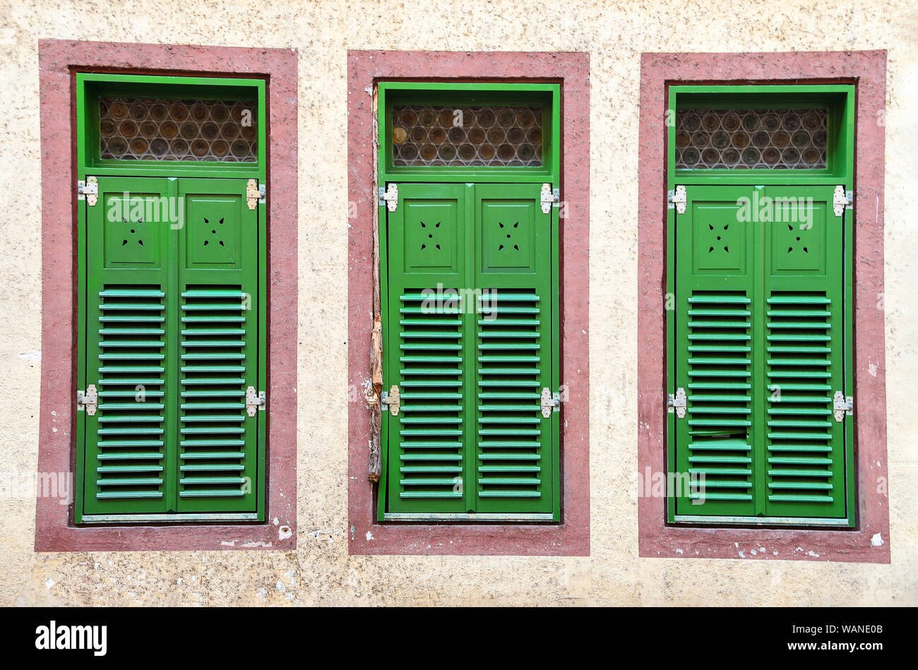 row of German house windows with bright green shutters Stock Photo