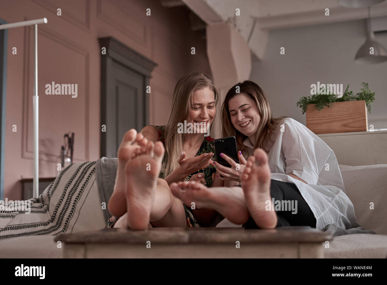 girls on couch Stock Photo Alamy