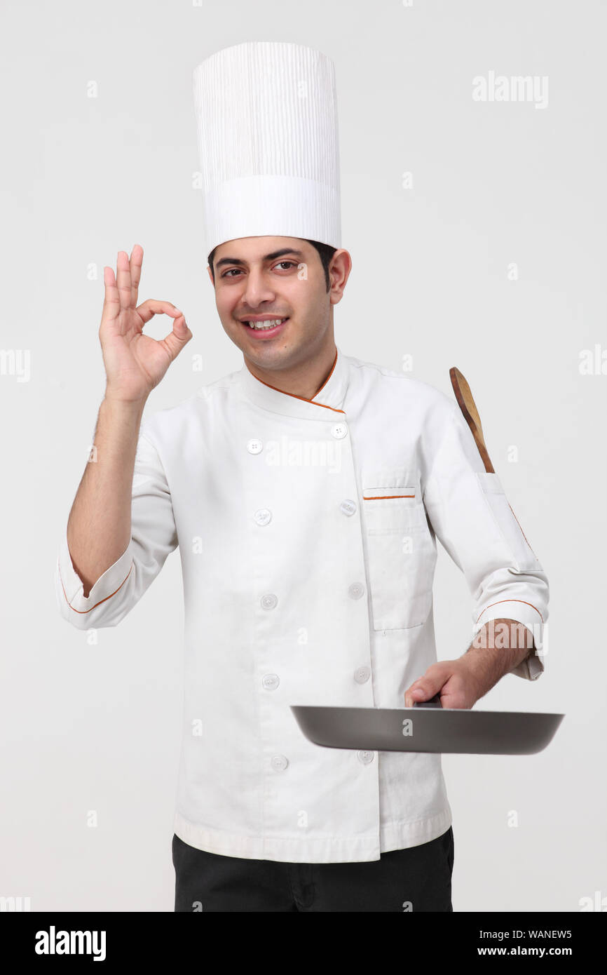 Chef preparing food and showing ok sign Stock Photo