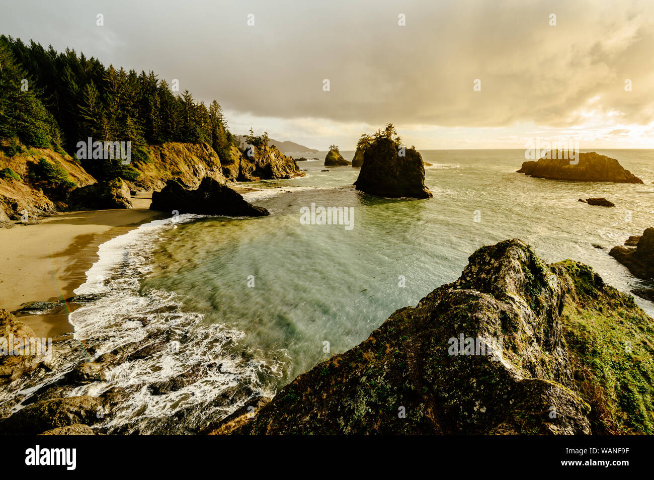 Sunset on the Oregon coast with haystack rocks in the distanc Stock Photo