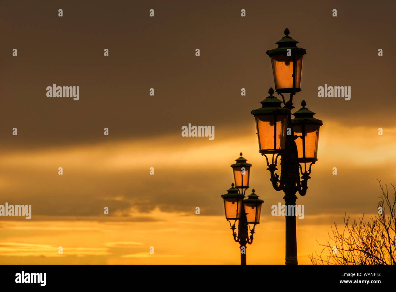 Old traditional Venice street lamps with golden sunset in a romantic and unique atmosphere (with copy space) Stock Photo